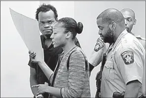  ?? AP/Atlanta Journal-Constituti­on/HENRY P. TAYLOR ?? Basil Eleby is escorted by his public defender and two sheriff’s deputies into the courtroom Saturday at the Fulton County jail in Atlanta.