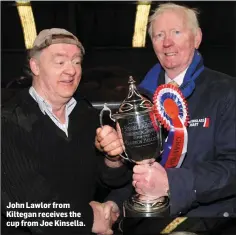  ??  ?? John Lawlor from Kiltegan receives the cup from Joe Kinsella.