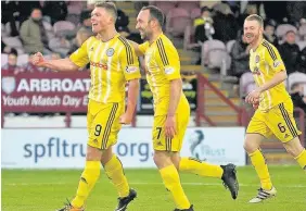  ??  ?? Joy boys Craig Moore, Michael Moffat and Andy Geggan celebrate at Gayfield