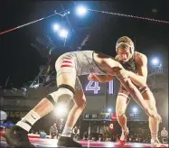  ?? Hayne Palmour IV / TNS ?? Stanford’s Nathan Traxler, right, and Fresno State’s Danny Salas wrestle in 2018. On Wednesday, Stanford eliminated 11 varsity sports, including wrestling.