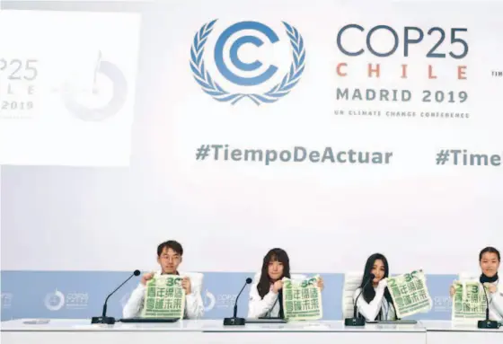  ??  ?? Delegates from the China Youth Climate Action Network (CYCAN) promote the “1000 Environmen­t-friendly Youth Ambassador­s Action” at the 25th United Nations Climate Change Conference in Madrid, Spain. courtesy of CYCAN