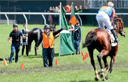  ?? GETTY ?? Horses are guided away from The Cliffsofmo­her after Ryan Moore pulled the injured animal up during the first circuit of the Melbourne Cup.