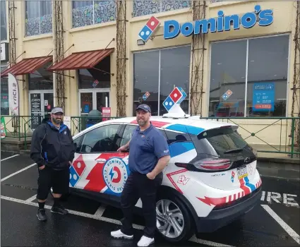  ?? DONNA ROVINS — MEDIANEWS GROUP PHOTO ?? Jonathan Gambler, manager of the Domino’s Pizza, 810Oley St. in Reading, right and John Colon, delivery driver, left, with one of the five electric vehicles in use for making deliveries in Berks County.