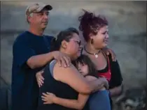  ?? DARRYL DYCK, THE CANADIAN PRESS ?? Randy Thorne, left, his wife Angie Thorne, second from left, their daughter Kelsey Thorne, and granddaugh­ter Nevaeh Porter, 8, are overcome with emotion as they view the remains of their home that was destroyed by wildfire near Ashcroft, B.C., late...