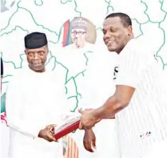  ??  ?? Vice President, Prof. Yemi Osinbajo (left) presents the Unity Cup prize to the patron of Profile Group team, Mohammad Babangida at the Unity Internatio­nal Polo Tournament held at the 12-12 Polo & Turf Club, Abuja.