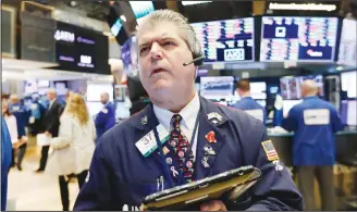  ??  ?? Trader John Panin works on the floor of the New York Stock Exchange on Oct 11. Stocks are slumping for a second straight day as the market endures its most volatile stretch since February. (AP)— See Page 26