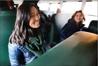  ?? NANCY LANE — BOSTON HERALD ?? Mayor Michelle Wu and School Superinten­dent Mary Skipper ride one of the new electric school buses on Monday.