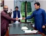  ?? Reuters file ?? RECEIVING DONATION: Prime Minister Imran Khan receives donation from Faisal Edhi in Islamabad. —