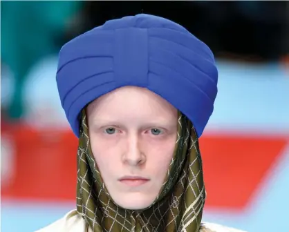  ?? Photograph: Pietro D'aprano/Getty Images ?? A model wearing the turban-style hat that Sikhs say does not respect their religion.