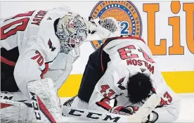  ?? ETHAN MILLER GETTY IMAGES ?? Braden Holtby, left, of the Washington Capitals checks on Tom Wilson after he was hurt in a collision with Ryan Reaves, not shown, of the Vegas Golden Knights on Tuesday.