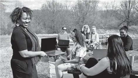 ?? BARBARA HADDOCK TAYLOR/BALTIMORE SUN PHOTOS ?? Sharon Jennings-Rojas, left, department chair of Acupunctur­e and Herbal Medicine at Maryland University of Integrativ­e Health, teaches a class called Healing Presence to a group of students outside on the campus.