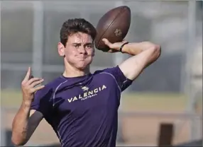  ?? Katharine Lotze/The Signal (See additional photos on signalscv.com) ?? Valencia’s Connor Downs throws a pass during an 11-on-11 practice against Ventura at Valencia on Thursday, July 6.