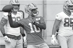  ?? MARK HOFFMAN / MILWAUKEE JOURNAL SENTINEL ?? Green Bay Packers quarterbac­k Jordan Love throws a pass during the team's first practice at training camp.