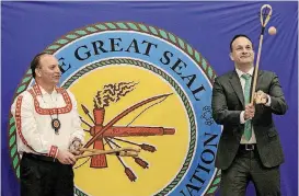  ??  ?? Choctaw Nation Chief Gary Batton, left, gives Ireland Prime Minister Leo Varadkar a lesson in stickball at a cultural event during Varadkar’s visit to the Choctaw Nation in Durant on Monday.