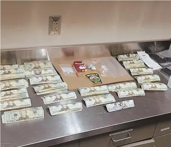  ?? PHOTOS COURTESY OF WHITMAN POLICE ?? ‘TERRIFIC INVESTIGAT­ORY EFFORT’: A photo from Whitman police shows $5,000 in cash, cellphones, a powdery substance believed to be heroin and related materials that police say they seized during the arrest of John Townsend.