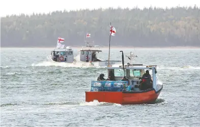  ?? ANDREW VAUGHAN / THE CANADIAN PRESS FILES ?? Potlotek First Nation boats head into St. Peters Bay in a self-regulated commercial lobster fishery on Oct. 1, which is
Treaty Day and recognizes the signing of peace and friendship treaties between the Mi'kmaq and the Crown.