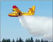  ?? — THE ASSOCIATED PRESS FILES ?? A CL-415 water bomber delivers a drop during a demonstrat­ion in Los Angeles in 2013.