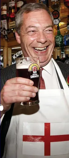  ??  ?? Cheers! Nigel Farage — sporting a patriotic apron — celebrates St George’s Day with a pint
