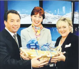  ?? ?? Joanne Morrissey, Ballyporee­n (centre) who was runner-up in the Irish Permanent Finance/Autowoman Magazine Competitio­n in 2001, a slogan based competitio­n to win a car. She is pictured accepting her prize from Chris Hanlon, Managing Director, Irish Permanent Finance and Mary Schwer-Foley of Autowoman Magazine.