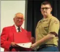 ??  ?? Marine Earle Drake presenting his award to Cadet Hunter Ford.