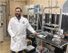  ?? TOM HENRY / THE (TOLEDO) BLADE ?? Jonathan Pressman explains the EPA’S Breidenbac­h Environmen­tal Research Center’s research into PFAS — known as “forever chemicals.”
