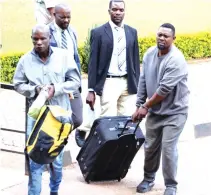  ?? ?? Majali Aribi Saidi and Shimdavala Mohammedi Shomari (in front) accompanie­d by detectives arrive to face theft charges at the Harare Magistrate­s Court yesterday
