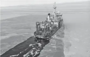  ?? JOHN GUILLOTE VIA AP ?? An aerial drone photo shows the U.S. research vessel Sikuliaq as it makes its way through ice in the Beaufort Sea off Alaska’s north coast. University of Washington scientists onboard the research vessel are studying how less sea ice will affect coastlines.