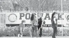  ?? SUSAN STOCKER/STAFF PHOTOGRAPH­ER ?? Parents wait outside the David Posnack Jewish Day School in Davie where a bomb threat was called in for the second time in nine days. Both incidents turned out to be hoaxes.