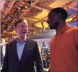  ?? Mike Anthony / Hearst Connecticu­t Media ?? Gov. Ned Lamont talks to former UConn football player Darius Butler, who played nine years in the NFL, at Mohegan Sun casino Thursday morning.