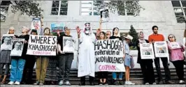  ?? JACQUELYN MARTIN/AP ?? Protesters hold signs outside the Saudi Embassy on Wednesday in Washington.