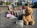  ?? LANCE REYNOLDS — BOSTON HERALD ?? A sidewalk shrine is gathering in Salem where Carl-Hens Beliard was shot dead.