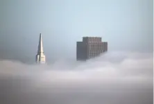  ?? Paul Chinn / The Chronicle 2015 ?? The former Bank of America building, with 30% owned by the Trump family, joins the Transameri­ca Pyramid above the fog.