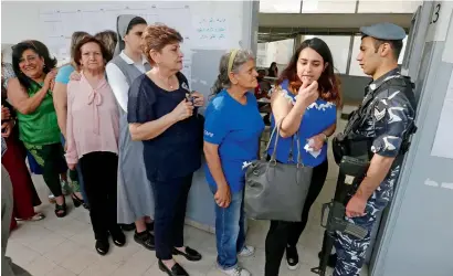  ?? —AFP ?? Women queue to vote at a polling station during the parliament­ary election in Beirut on Sunday.