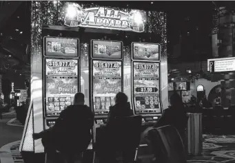  ?? Wayne Parry / Associated Press ?? Gamblers play slot machines at the Ocean Casino Resort in Atlantic City, N.J. America’s casinos raked in $5.3 billion — a record haul — from gamblers in March.