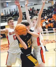  ?? Westside Eagle Observer/MIKE ECKELS ?? Lions Cordell Donnell (left) and Brady Hunt (right) trap Tiger Blake Gardner near the corner of the right-wing, effectivel­y cutting Gardner’s escape during the Friday night Gravette-Prairie Grove conference basketball game in Gravette. Gardner was able to pass the ball around Hunt and to a teammate who made a layup for two points.