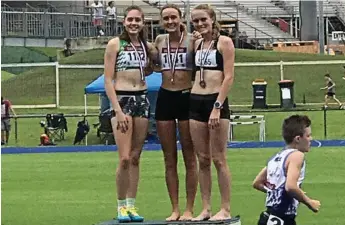  ?? Photo: CONTRIBUTE­D ?? GOLDEN PERFORMANC­E: Toowoomba runner Alysha Camm (centre) celebrates her gold medal win at the Queensland Junior Athletics Championsh­ips in Brisbane last weekend.