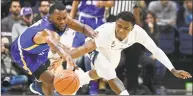  ?? Jessica Hill / Associated Press ?? Morehead State’s A. J. Hicks, left, and UConn’s Christian Vital, right, chase down a loose ball on Thursday.