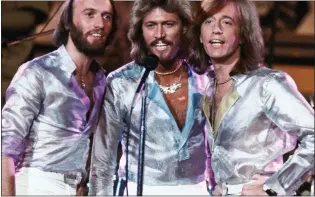  ??  ?? REGRETS: Barry Gibb, centre, with brothers Maurice, far left, and Robin on stage in 1979