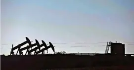  ?? [PHOTO BY DANIEL ACKER, BLOOMBERG] ?? Four pumpjacks are silhouette­d as they operate at the site of an oil well outside Williston, N.D., in 2015.