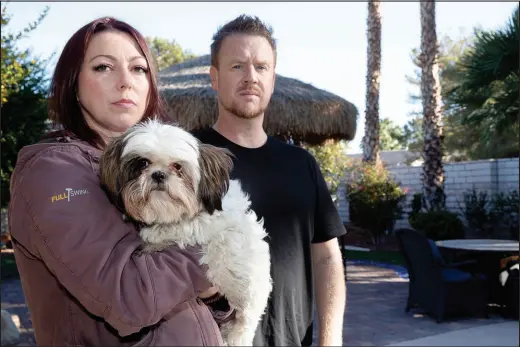  ?? STEVE MARCUS ?? Sean and Teri Cornwall, holding one of the couple’s four dogs, want to find the person responsibl­e for poisoning dogs in their neighborho­od.