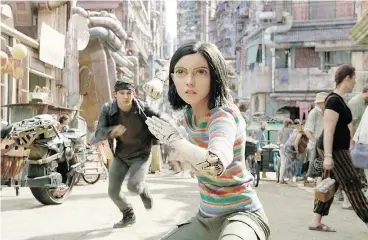  ??  ?? Alita quickly relearns the concept of love after meeting local gadabout Hugo (Keean Johnson), rear, and also gets reacquaint­ed with her battle skills.