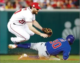  ?? Associated Press photo ?? Washington Nationals’ second baseman Daniel Murphy (20) jumps after forcing out Chicago Cubs’ Jon Jay (30) on a ball hit by Kris Bryant, who was safe at first during seventh the inning of Game 5 of a baseball National League Division Series, at...