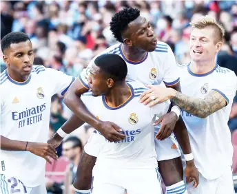  ?? — AFP photo ?? Real Madrid’s defender David Alaba (second left) celebrates scoring the opening goal during the Spanish La Liga match against FC Barcelona at the Camp Nou stadium in Barcelona.