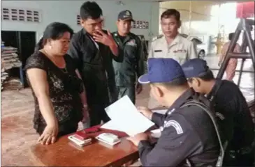  ?? SUPPLIED ?? Prominent alleged timber trader Nguyen Thimay (left), also known as ‘Grandma May’ is questioned after a bust in July in Kampong Thom province.