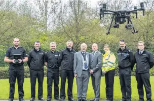  ??  ?? Chair of the Fire Authority, Cllr Bob Rudd, and the Police and Crime Commission­er for Cheshire, David Keane, take a closer look at the UAV