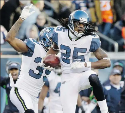  ?? AP PHOTO/ NAM Y. HUH ?? Seattle Seahawks cornerback Richard Sherman, front, celebrates an intercepti­on with teammate Brandon Browner against Chicago. The pair will play key roles in the playoff game against Atlanta on Sunday.