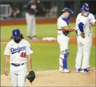  ?? Associated Press ?? TOUGH — Los Angeles Dodgers starting pitcher Tony Gonsolin leaves the game during the fifth inning in Game 2 of the National League Championsh­ip Series against the Atlanta Braves on Tuesday in Arlington, Texas.