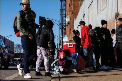  ?? ?? A three-year-old Venezuelan girl sits next to her mother as she is selling food outside a migrant shelter in Chicago on 15 February 2024. Photograph: Armando L. Sanchez/Chicago Tribune via Getty Images