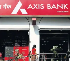  ?? /Reuters ?? Growth potential: A customer enters a branch of Axis Bank in Mumbai. Investing in Axis shares could yield an investor healthy returns as the bank benefits from strong GDP growth.