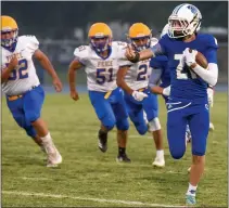  ??  ?? Orland’s Michael Lister outruns several defenders during the Trojans’ season opener against Pierce on Friday in Orland.